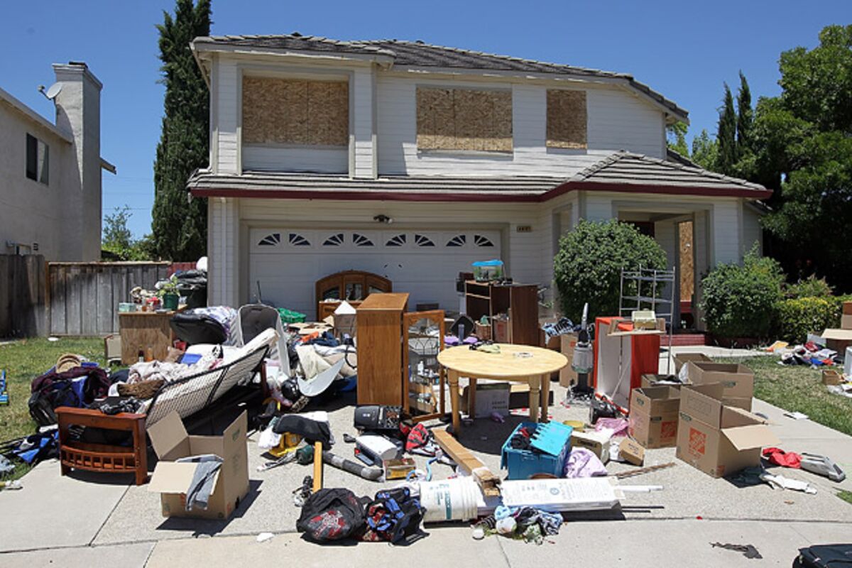 Overflowing household junk and furniture piled in a driveway before cleanup by Junk removal services kent wa for residential cleanouts.